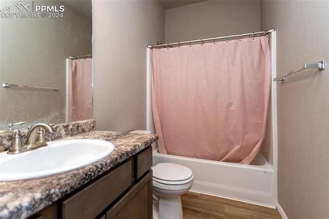 full bathroom featuring vanity, toilet, hardwood / wood-style flooring, and shower / bath combo