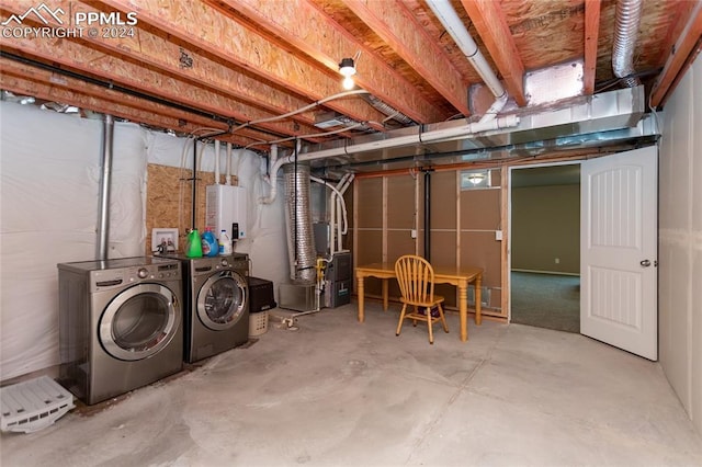 basement featuring heating unit and washer and dryer