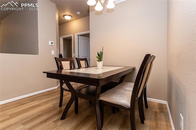 dining space featuring a chandelier and hardwood / wood-style flooring