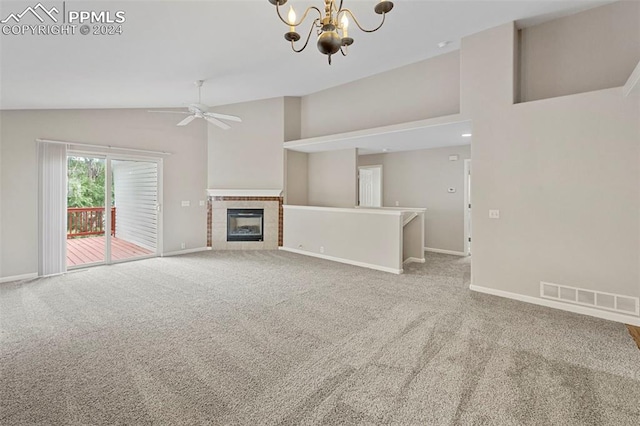 unfurnished living room with carpet, visible vents, a tile fireplace, baseboards, and ceiling fan with notable chandelier