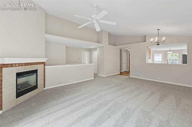 unfurnished living room featuring lofted ceiling, visible vents, carpet flooring, and a tile fireplace