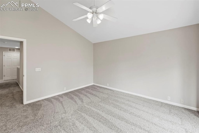 carpeted empty room with lofted ceiling and ceiling fan