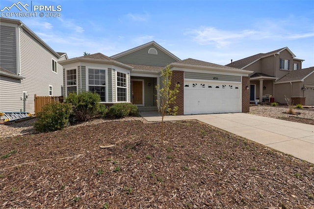 ranch-style home with brick siding, driveway, and an attached garage