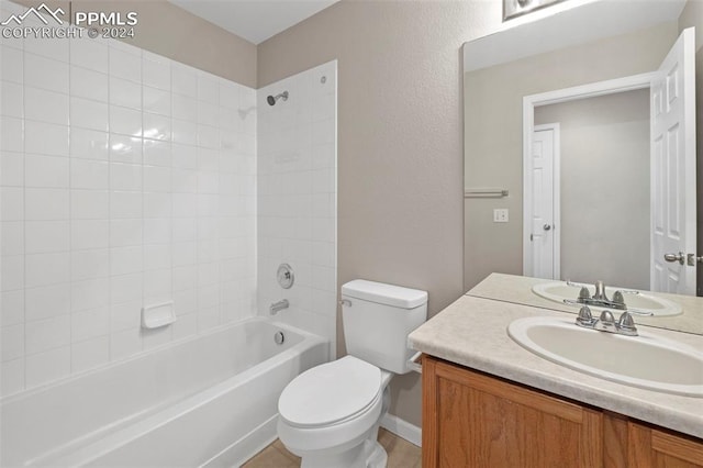 bathroom with  shower combination, a textured wall, vanity, and toilet