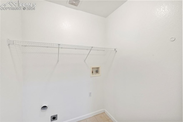 laundry area featuring electric dryer hookup, light tile patterned floors, and hookup for a washing machine