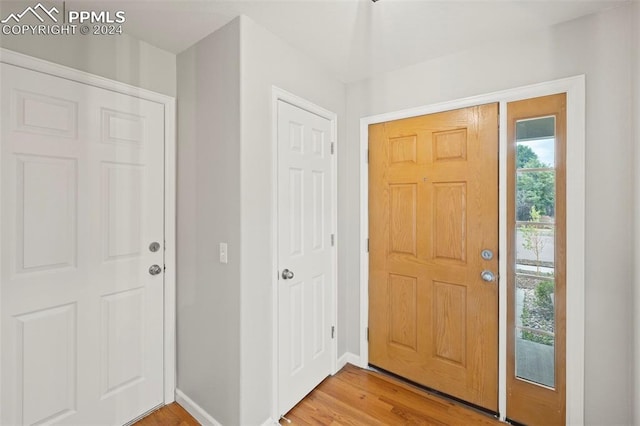 foyer entrance featuring light wood-style floors and baseboards