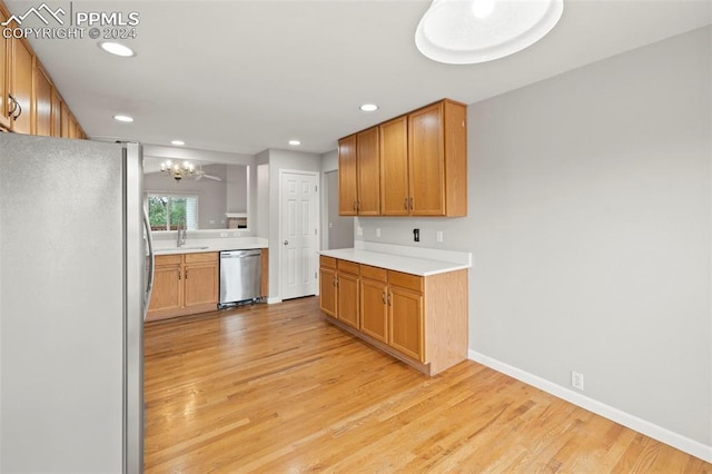 kitchen featuring an inviting chandelier, appliances with stainless steel finishes, and light wood-type flooring