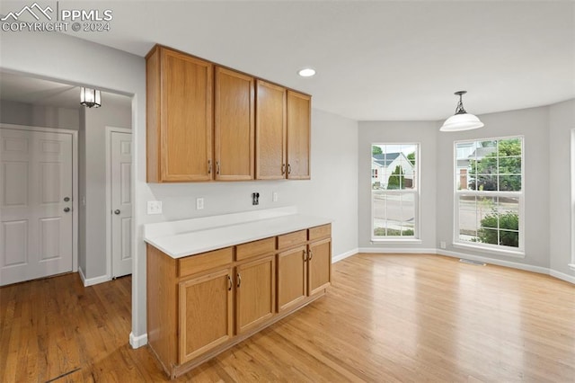 kitchen featuring pendant lighting and light wood-type flooring