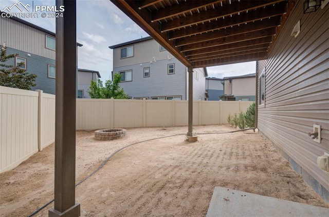 view of yard featuring an outdoor fire pit and a patio area