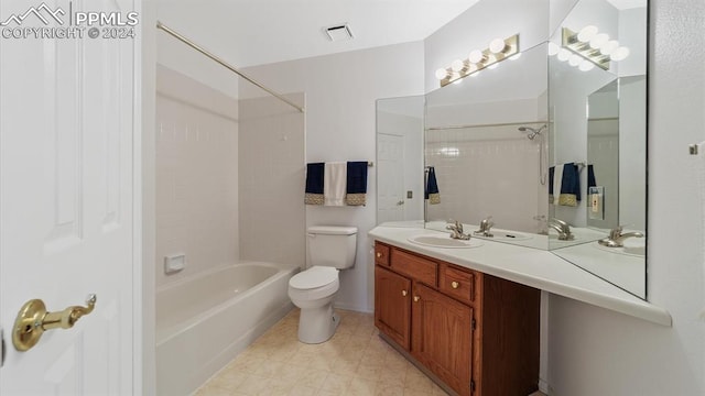 full bathroom featuring vanity, tiled shower / bath, tile patterned flooring, and toilet