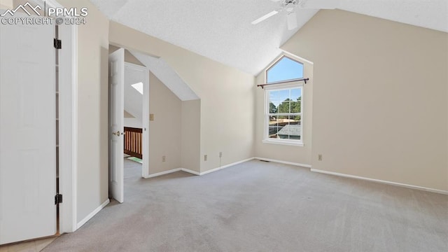 bonus room with light carpet, ceiling fan, and vaulted ceiling