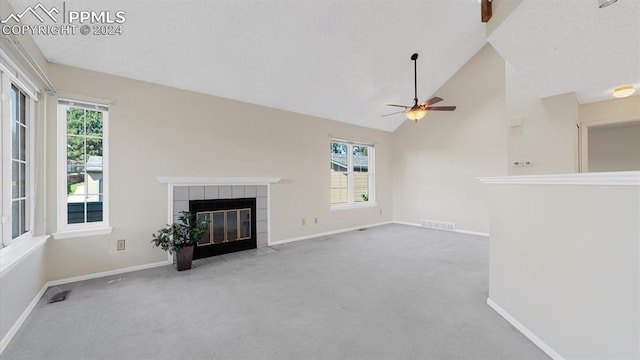 unfurnished living room featuring carpet, ceiling fan, and a wealth of natural light