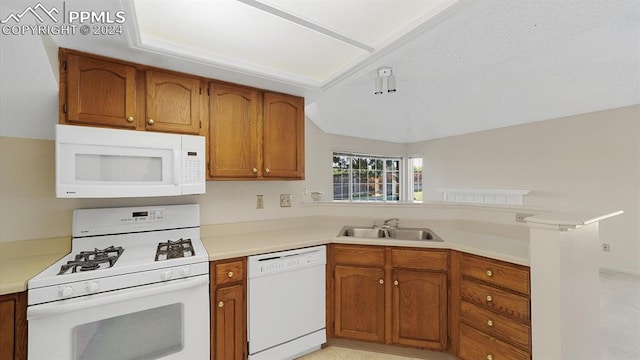 kitchen with white appliances, sink, and kitchen peninsula