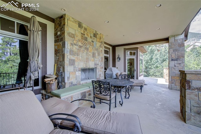 4950 Longwood Pt, Colorado Springs, CO 80906 - view of patio featuring an outdoor stone fireplace, a grill, and outdoor dining area