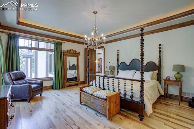 4950 Longwood Pt, Colorado Springs, CO 80906 - bedroom with light wood-type flooring, a tray ceiling, a chandelier, and crown molding