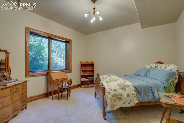 4950 Longwood Pt, Colorado Springs, CO 80906 - bedroom featuring light carpet, baseboards, and an inviting chandelier