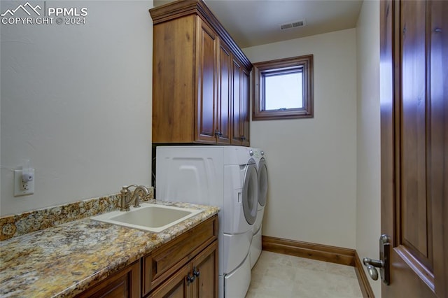 4950 Longwood Pt, Colorado Springs, CO 80906 - laundry room with cabinet space, baseboards, visible vents, separate washer and dryer, and a sink
