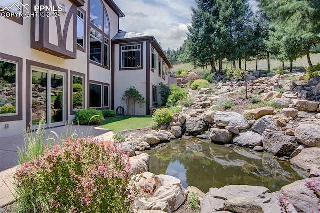 4950 Longwood Pt, Colorado Springs, CO 80906 - view of yard featuring a garden pond