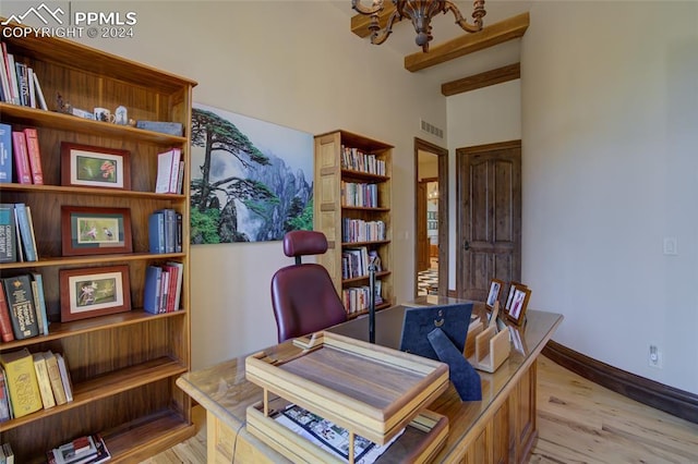 4950 Longwood Pt, Colorado Springs, CO 80906 - home office with visible vents, baseboards, light wood-style flooring, beamed ceiling, and a chandelier