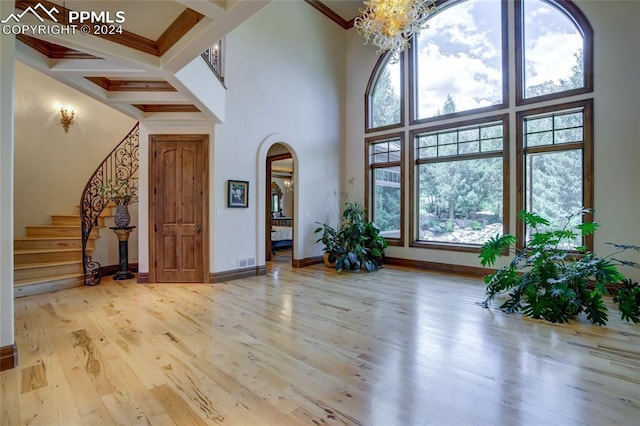 4950 Longwood Pt, Colorado Springs, CO 80906 - foyer with arched walkways, coffered ceiling, baseboards, and wood finished floors
