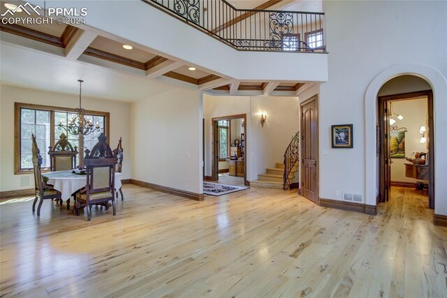 4950 Longwood Pt, Colorado Springs, CO 80906 - entryway featuring baseboards, arched walkways, coffered ceiling, and hardwood / wood-style floors
