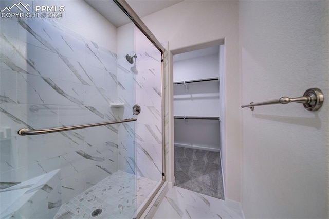 bathroom with a shower with shower door