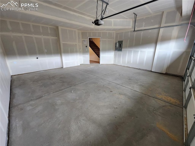 garage featuring electric panel and a garage door opener