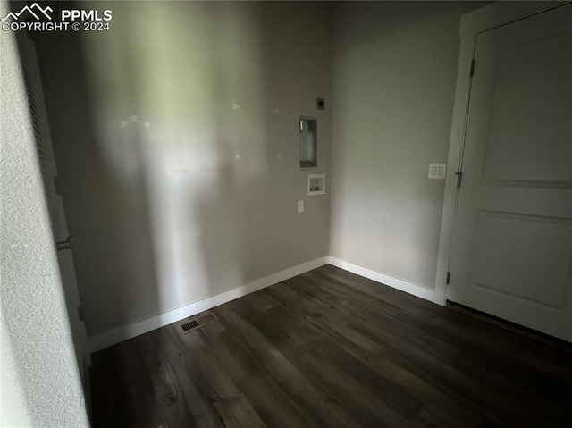 unfurnished room with dark wood-type flooring