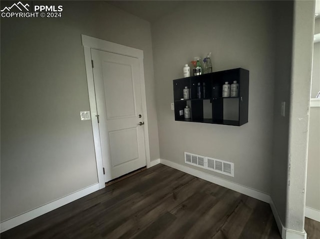 empty room featuring dark wood-type flooring