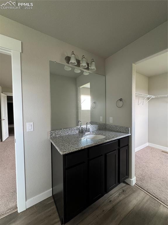 bathroom with vanity and hardwood / wood-style floors