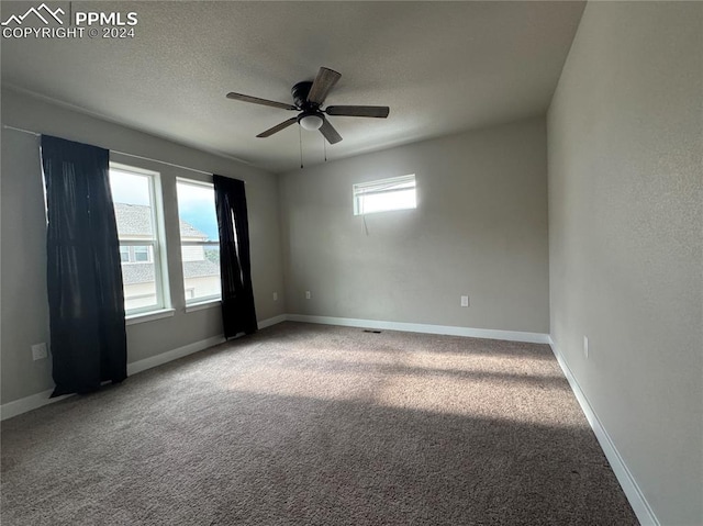 unfurnished room with ceiling fan and carpet flooring