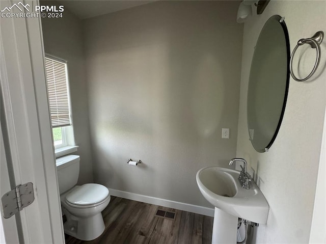 bathroom featuring toilet and hardwood / wood-style flooring