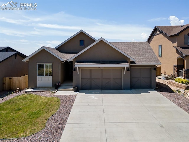 view of front of property with a garage and a front lawn