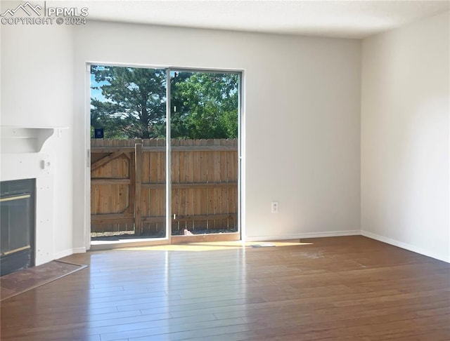 unfurnished living room with dark hardwood / wood-style flooring