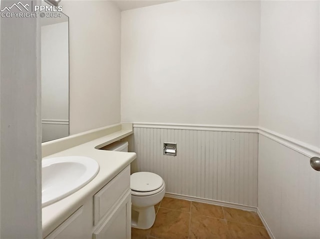 bathroom with vanity, toilet, and tile patterned floors