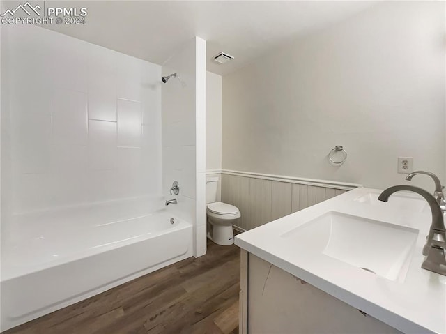 full bathroom with  shower combination, hardwood / wood-style flooring, toilet, and vanity