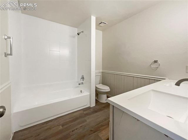 full bathroom featuring bathtub / shower combination, hardwood / wood-style floors, toilet, and vanity