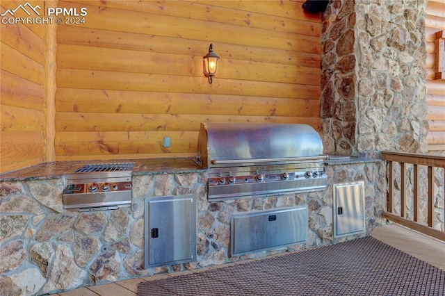 view of patio featuring exterior kitchen and a grill