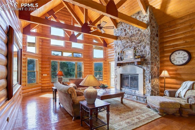 living room with wood ceiling, a fireplace, beamed ceiling, and hardwood / wood-style flooring