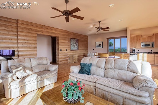 living room with ceiling fan, light wood-style floors, log walls, and recessed lighting