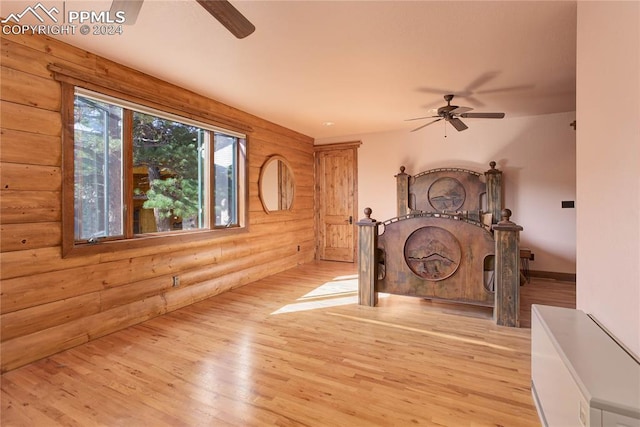 interior space with log walls and light wood-style flooring