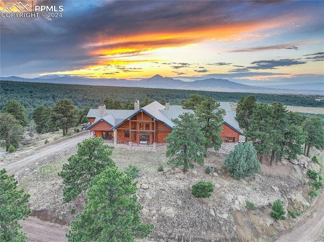 aerial view at dusk featuring a mountain view