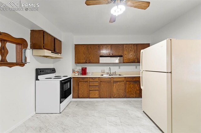 kitchen featuring light tile patterned floors, white appliances, sink, and ceiling fan