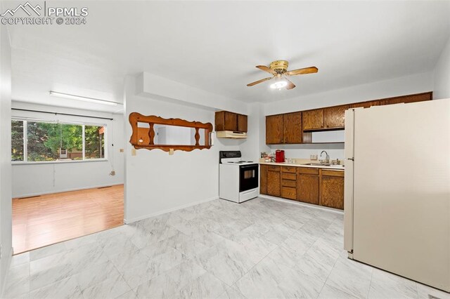 kitchen featuring light tile patterned flooring, white appliances, sink, and ceiling fan