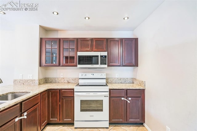 kitchen featuring light stone counters, sink, light tile patterned floors, and white range with electric stovetop