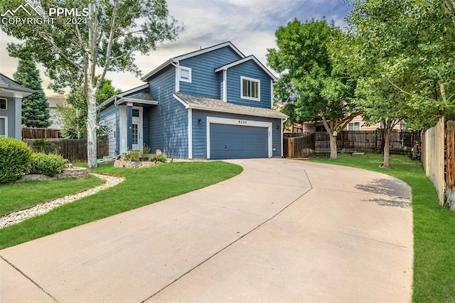 view of property featuring a front yard and a garage