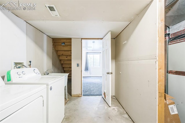 clothes washing area with washing machine and dryer