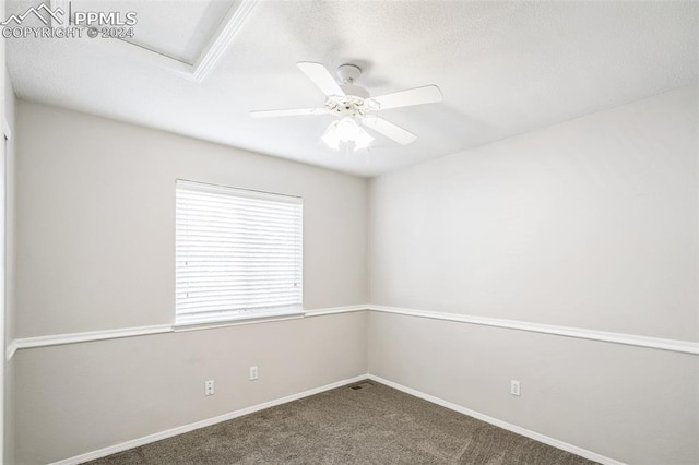 carpeted spare room featuring ceiling fan