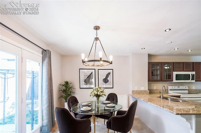 dining area featuring sink and a notable chandelier