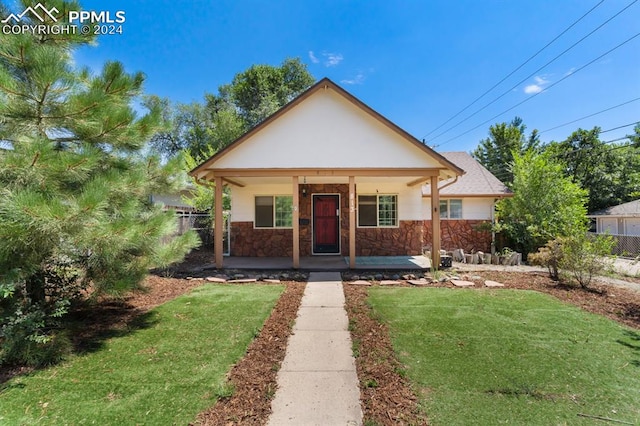 bungalow-style house with covered porch and a front lawn